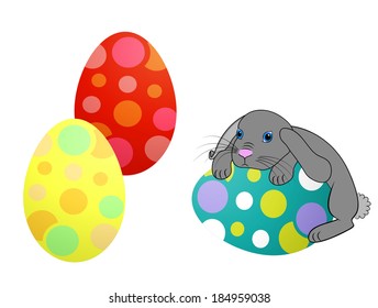 Little Easter bunny rabbit with decorated Easter eggs