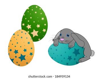 Little Easter bunny rabbit with decorated Easter eggs