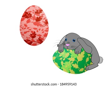 Little Easter bunny rabbit with decorated Easter eggs