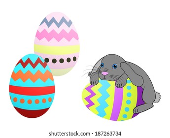 Little Easter bunny rabbit with decorated Easter eggs