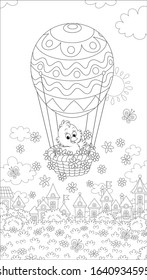 Little Easter chick flying in its holiday basket with a decorated balloon above a small toy town on a sunny spring day, black and white vector cartoon illustration for a coloring book page