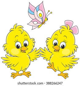Little Easter chickens dancing with a butterfly