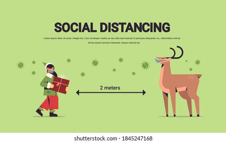 little elf santa claus helper with reindeer in masks keeping social distance to prevent coronavirus happy new year merry christmas holidays celebration concept full length horizontal copy space vector