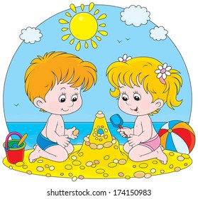 Little girl and boy building a sand castle on a beach