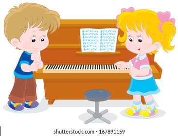 Little girl and boy playing a piano in a musical class