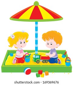 Little girl and boy playing in a sandbox on a playground