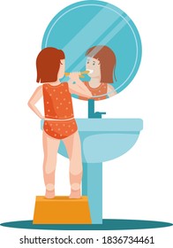 Little girl brushes her teeth and looks in the mirror