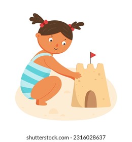 Little girl building sand castle on summer beach