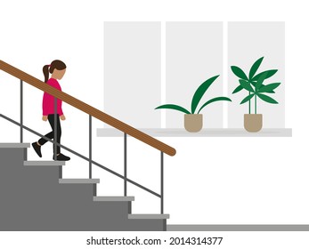 Little girl descends the stairs against the background of a wall with a window and plants