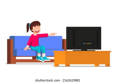 a little girl enjoys watching television while sitting on the sofa