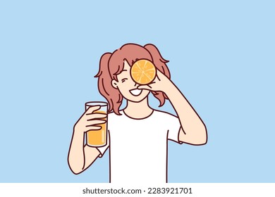 Little girl with glass of orange juice in hands smiling holding half of citrus fruit near face. Happy teenager recommends using orange juice containing healthy vitamins for immunity and health 