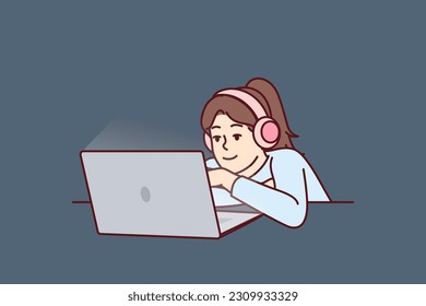 Little girl in headphones uses laptop watching children series or internet show for schoolchildren. Concept children internet addiction and need for restrictions in use of gadgets for children