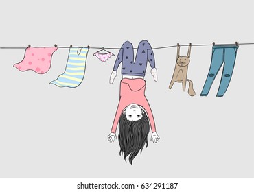 Little girl and her beloved cat are enjoying the holidays.Both of them naughty play on the clothesline in the summer