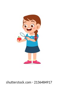 little girl holding apple and magnifying glass