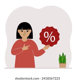 A little girl holds a percent sign in his hand. The concept of percentage, discount, promotion for training or shopping.