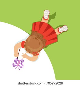 Little girl lying her stomach   painting purple butterfly  top view child the floor