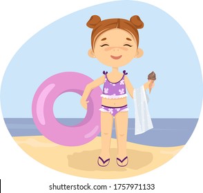 Little girl on the beach by the sea, playing and swimming with an inflatable circle  and eating ice cream