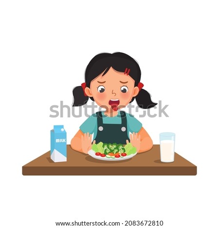 Little girl picky eater refusing to eat showing disgust facial expression and hands pushing at bowl of fruits and vegetables.