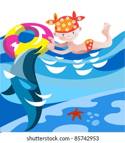 Little girl playing with dolphins in the clear sea water