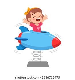 little girl playing on a spring rocket with her arms raised up smiling