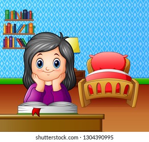Little girl reading a book in the room