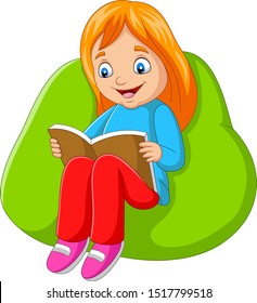 Little girl reading a book sitting on big pillow