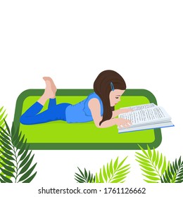 Little girl reads a book and is lying. Distance learning. Home education. School girl girl doing homework. Child with a book in her hands. Bookcrossing.