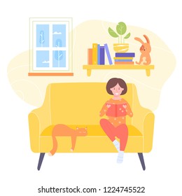 little girl sits in a chair and reads a book. There are books, a plant and a plush toy on the shelf. Outside the window, winter trees. Evening comfort, gaining knowledge, interesting stories.