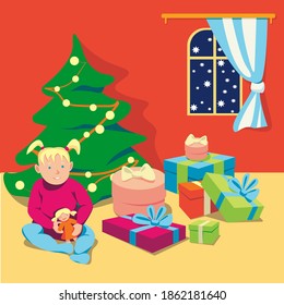 The little girl is sitting on floor near christmas tree with gifts