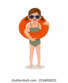 Little girl with swimsuit holding inflatable swim ring circle around having fun on summer time