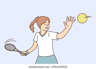 Little girl tennis player trains by hitting ball with racket, wanting to score goal for opponent in order to win tournament. Teenage schoolgirl playing tennis enjoying favorite hobby in spare time