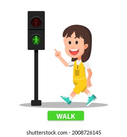 little girl walks according to the pedestrian light indicator
