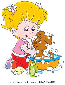 Little girl washes a small pup in a basin with lather 