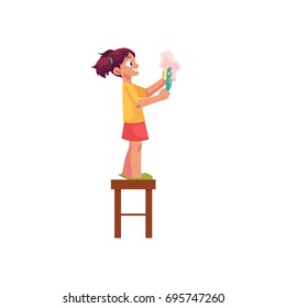 Little girl washing a plate, standing on stool, daily routine, cartoon vector illustration isolated on white background. Cartoon little girl washing a plate with sponge and soap, helping mother