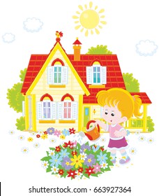 Little girl watering colorful flowers on a flowerbed in front of her house