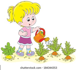 Little girl watering vegetables in a kitchen garden