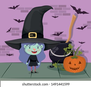 little girl with witch costume and cauldron and broom