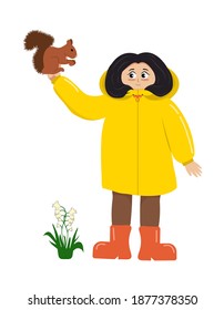 A little girl in a yellow raincoat and rubber boots holds a squirrel that eats a nut. Bells bloom underfoot. Flat illustration isolated on white background in vector.