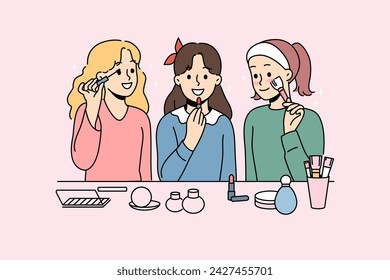 Little girls do makeup using lipstick and mascara or powder to prepare for school party. Schoolgirls want to be like mothers and put on makeup, getting ready to date boys from classmates.