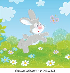Little grey long-eared rabbit jumping and playing with a small colorful butterfly on green grass of a forest glade on a wonderful summer day, vector illustration in a cartoon style