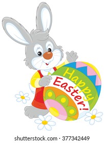 Little grey rabbit and a decorated egg with a Happy Easter greeting