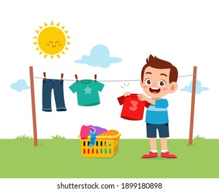 Little Kid Helping To Do Chores And Dry The Clothes Outside