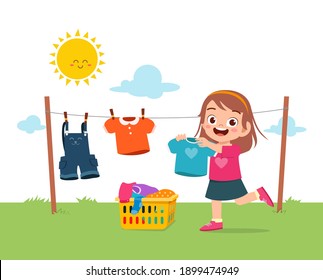 Little Kid Helping To Do Chores And Dry The Clothes Outside