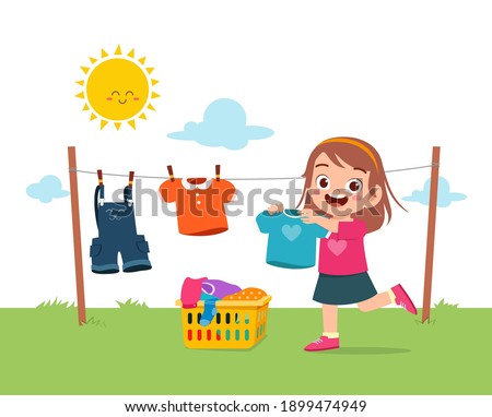 little kid helping to do chores and dry the clothes outside