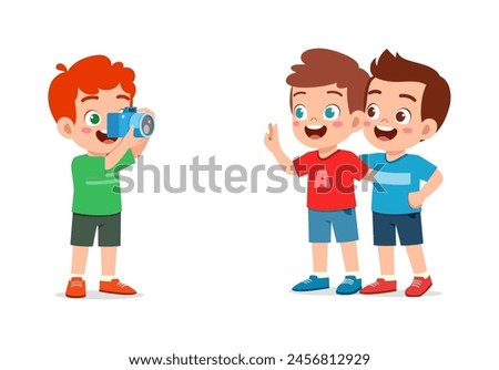 little kid holding camera and take photo of friend