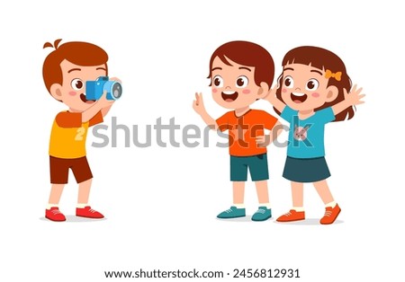 little kid holding camera and take photo of friend