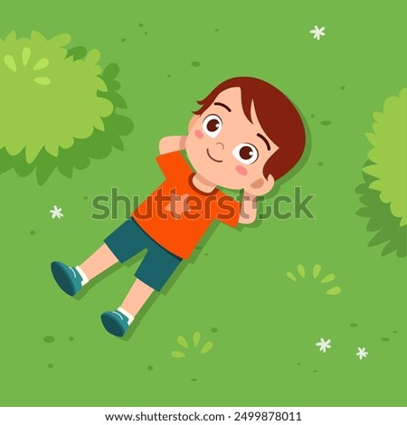 little kid lay down on park and feel happy