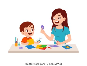 little kid make craft from paper with mother