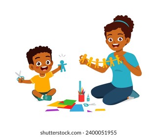 little kid make craft from paper with mother