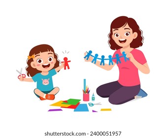 little kid make craft from paper with mother